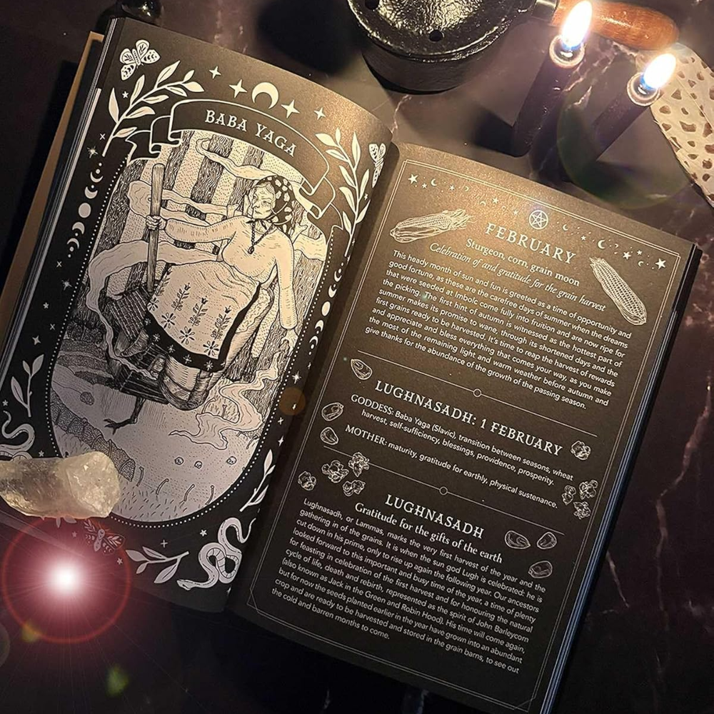 An open tarot deck book titled 'Bara Laga' and 'February' spread, displayed on a dark marble surface with candles, a metal cauldron, and a crystal.