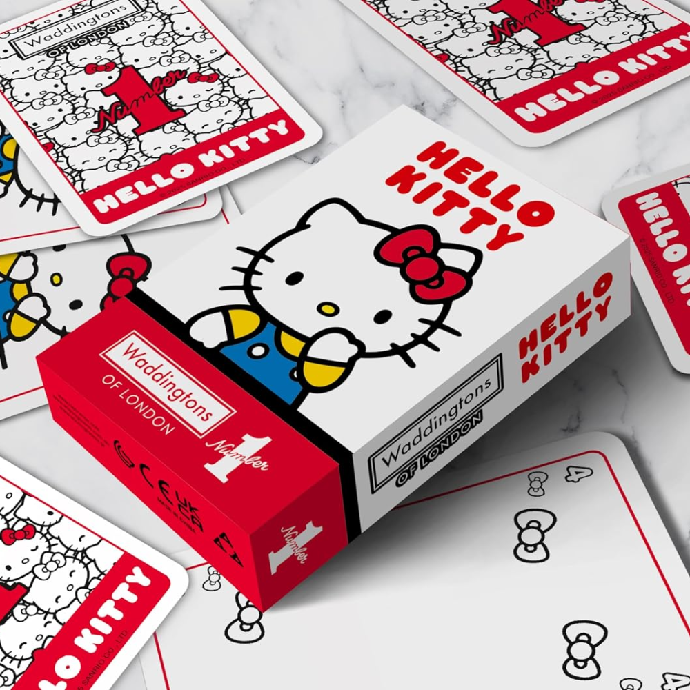 Hello Kitty playing cards with a box on a marble surface