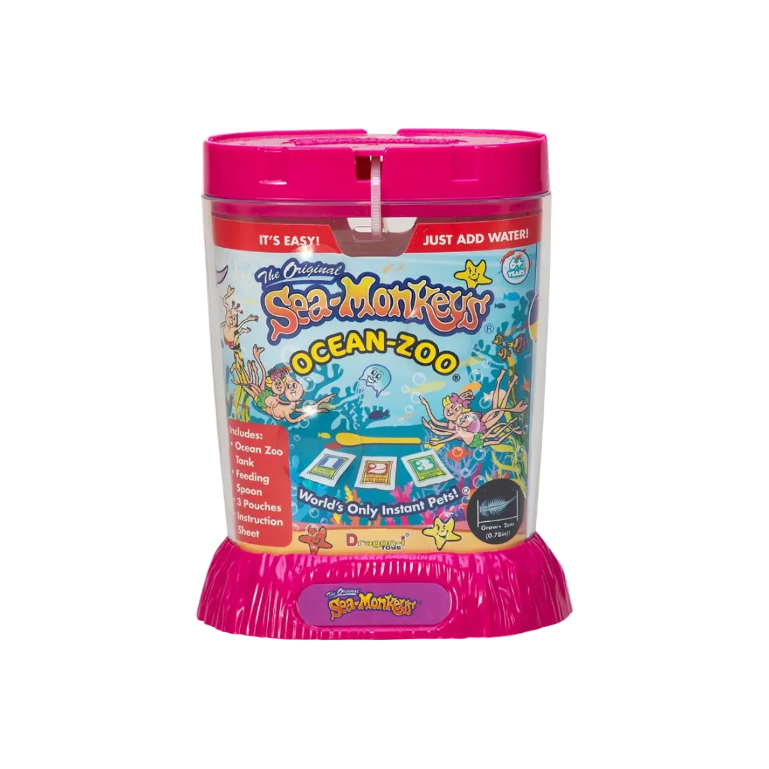 The Original Sea Monkeys Ocean-Zoo pet training toy in a bright pink cylindrical container with colorful underwater-themed packaging graphics and included training cards, tank, spoon, and pouches visible through the clear front.