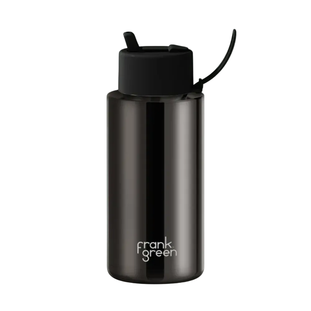 A dark metallic gray Frank Green water bottle with a black flip-top lid and carrying loop, set against a solid pale mint green background.