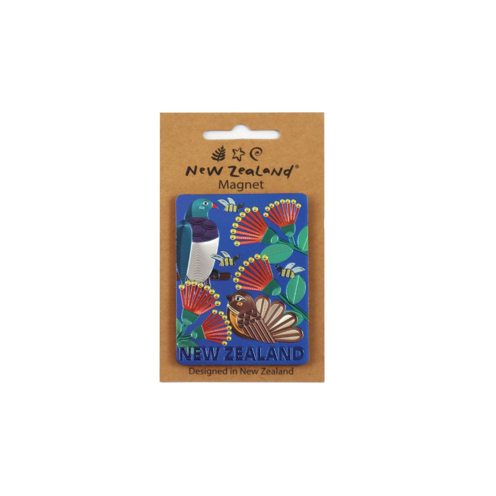 A New Zealand-themed enamel magnet on its original brown cardboard backing. The magnet features a blue background decorated with a pōuri (New Zealand bird), red and yellow neuria flowers, green leaves, and honey bees, with 'NEW ZEALAND' written at the bottom.