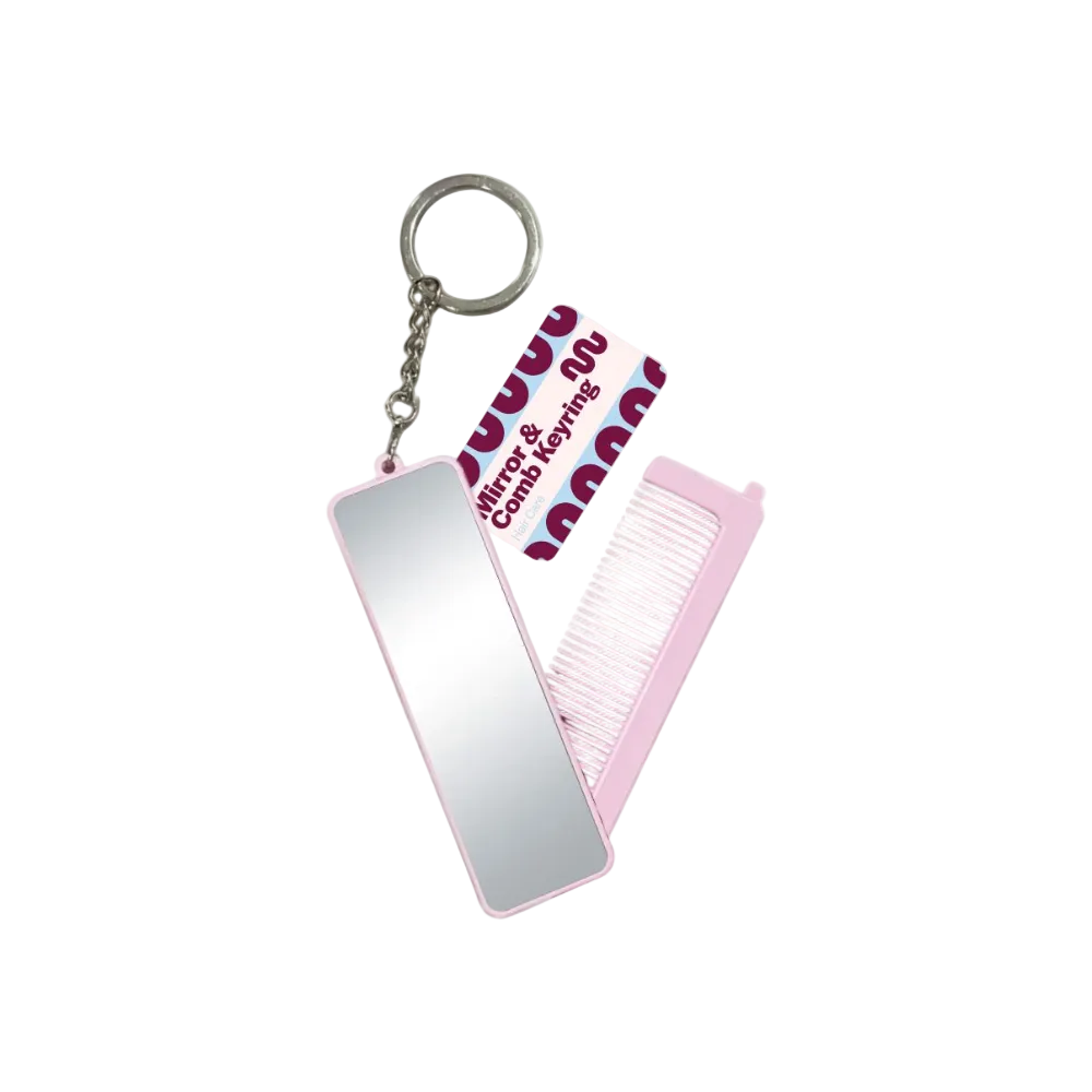 A pink and silver keychain mirror comb with a built-in mirror, a folding pink comb, and a branded paper tag that reads 'Mirror & Comb Keyring' on a white background.