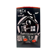 A black Halloween treat bag with a scalloped orange top edge, featuring a white haunted house illustration, bats, spiderwebs, pumpkins, and the text 'TRICK or treat' and 'HAPPY HALLOWEEN'S'.