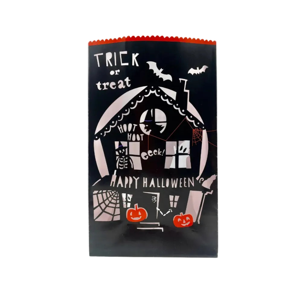 A black Halloween treat bag with a scalloped orange top edge, featuring a white haunted house illustration, bats, spiderwebs, pumpkins, and the text 'TRICK or treat' and 'HAPPY HALLOWEEN'S'.
