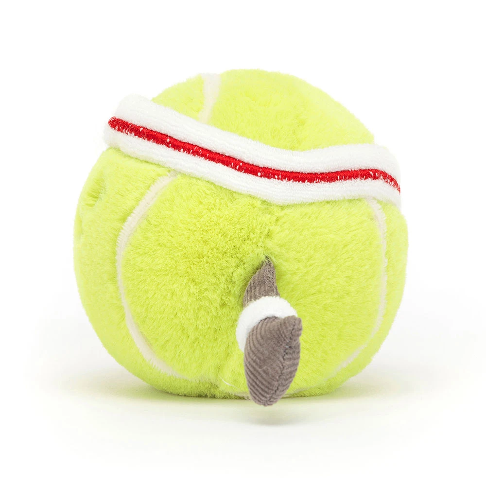Plush toy resembling a tennis ball with a red band on a white background