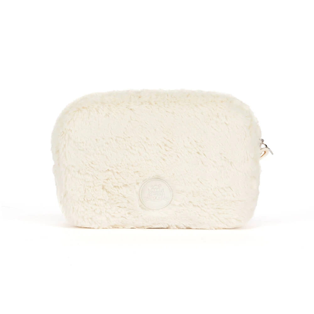 An off-white faux fur cosmetic pouch with a silver zipper pull and a circular embossed logo on the front, set against a plain white background.