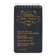 A spiral-bound notebook with a dark chalkboard-style cover featuring gold gothic text that reads 'Ghosts WERE PEOPLE TOO' and additional humorous phrases below, shown on a plain white background.
