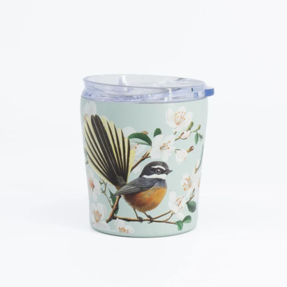 A clear plastic travel tumbler with a light blue lid and a printed illustration of a brown and gray bird perched on a branch with white blossoms on a pale green background.