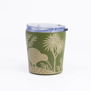 An olive green insulated tumbler with a clear lid, decorated with a beige kiwi bird and palm tree design, on a white background.