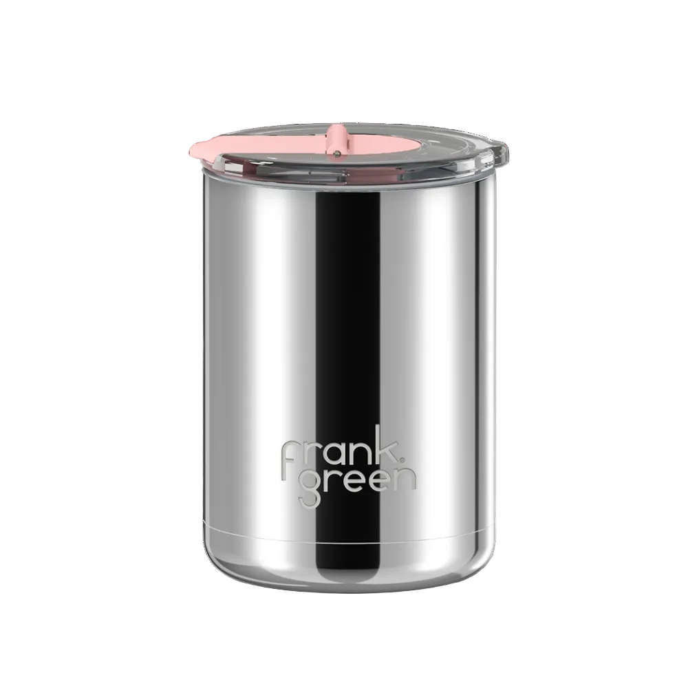 A stainless steel travel tumbler with a clear lid and a light pink straw, featuring the 'frank green' logo near the bottom, set against a plain white background.