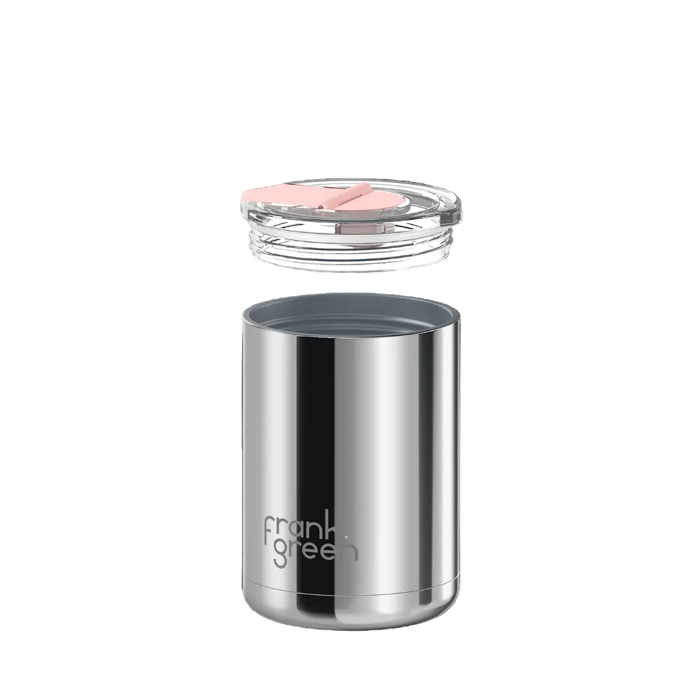 A stainless steel travel tumbler with a clear lid and a pink silicone straw insert, shown floating against a solid white background. The brand name 'frank green' is printed on the lower front of the tumbler.