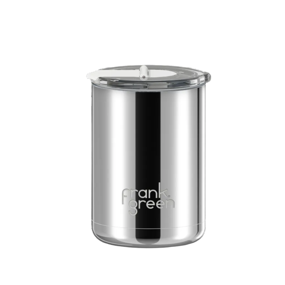 A stainless steel travel tumbler with a clear lid and the 'frank green' logo printed on the front, set against a plain white background.