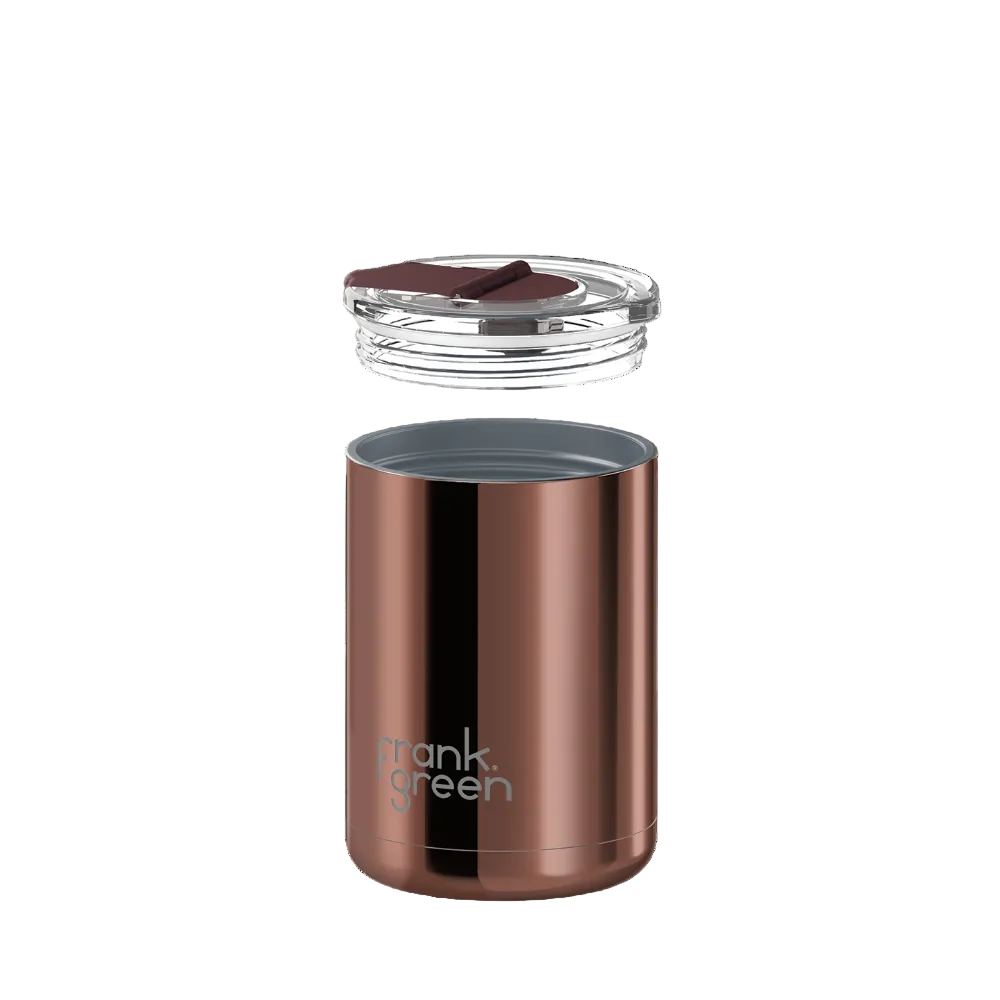 A metallic rose gold insulated travel tumbler with a clear lid and dark brown straw, shown against a solid white background. The brand name 'mank green' is printed in white near the bottom.