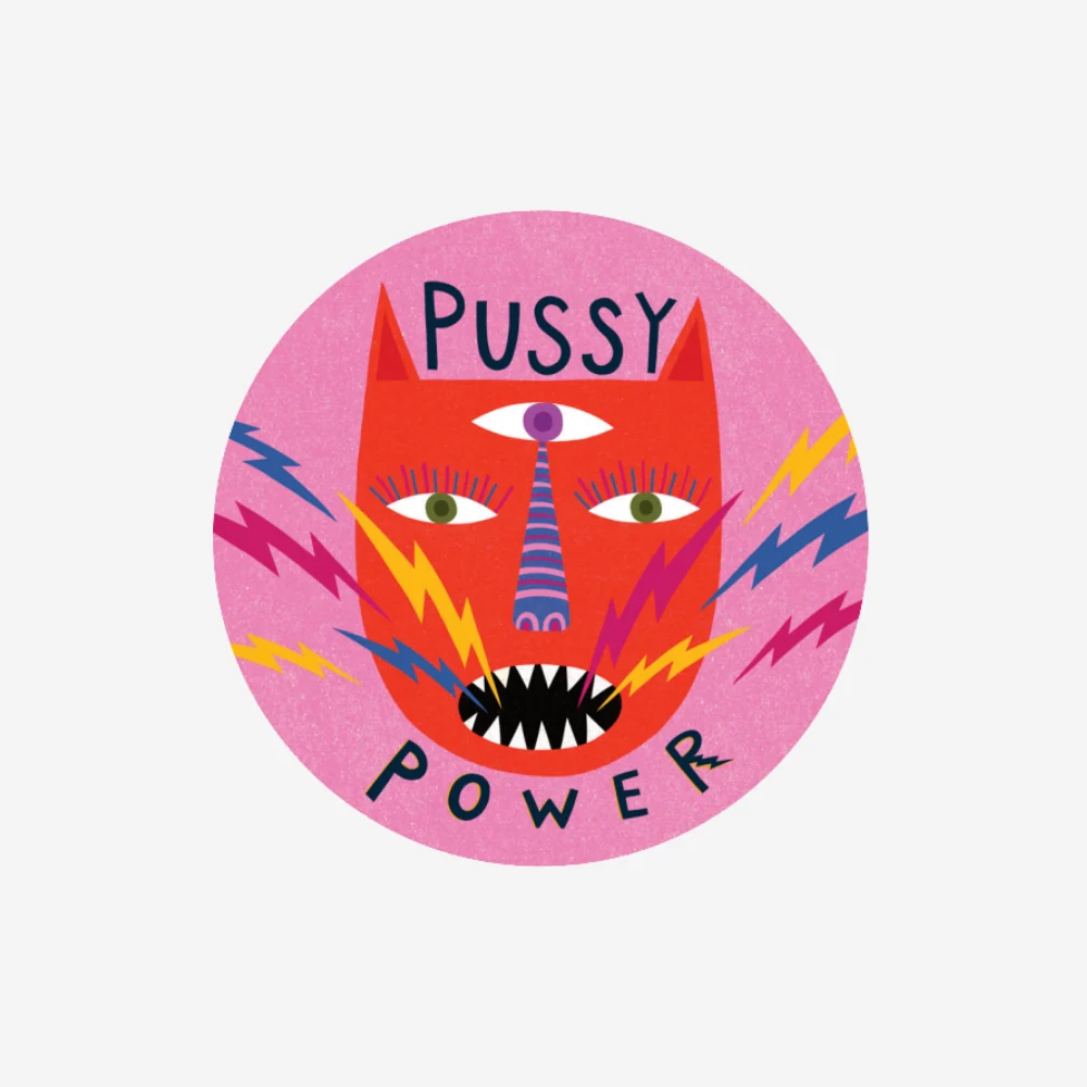A circular graphic sticker or print featuring a stylized red cat face with a purple horn, colorful lightning bolts, and the words 'PUSSY POWER' on a light gray background.