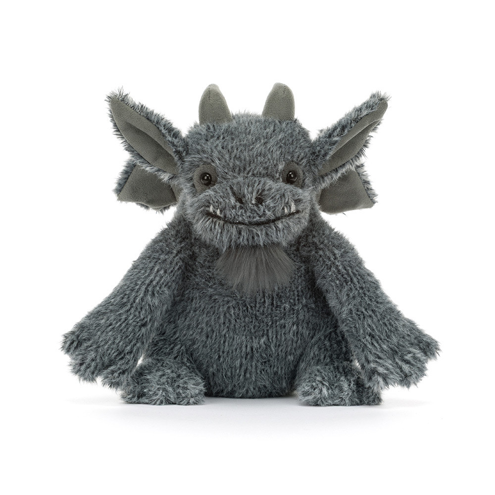 A gray plush dragon toy with large pointed ears, small horns, and a stitched smiling face, photographed against a clean white background.