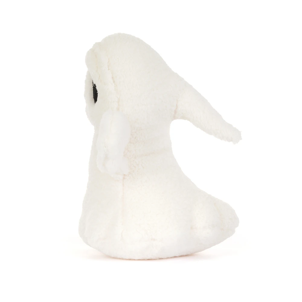 A small white plush bunny toy with a single black eye, photographed against a seamless white background.