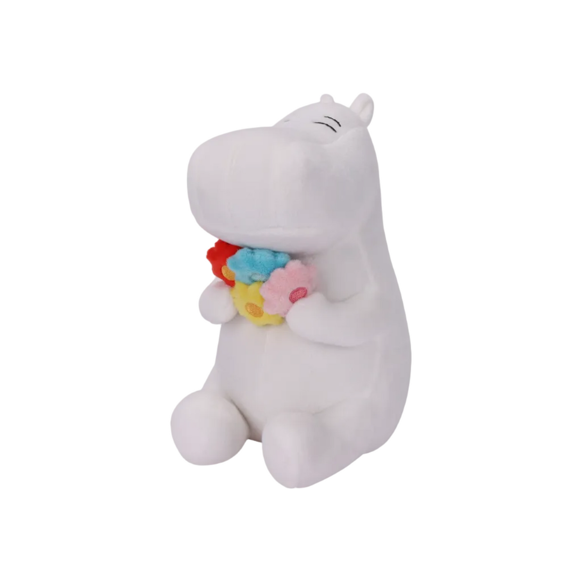 A white plush hippo toy sitting and holding a small colorful flower bouquet with red, blue, yellow, and pink flowers, photographed on a clean white background.