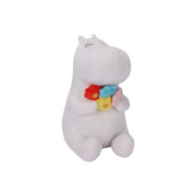 A white plush hippo toy holding a small bouquet of colorful flowers, including red, yellow, blue, pink, and light green, on a plain white background.