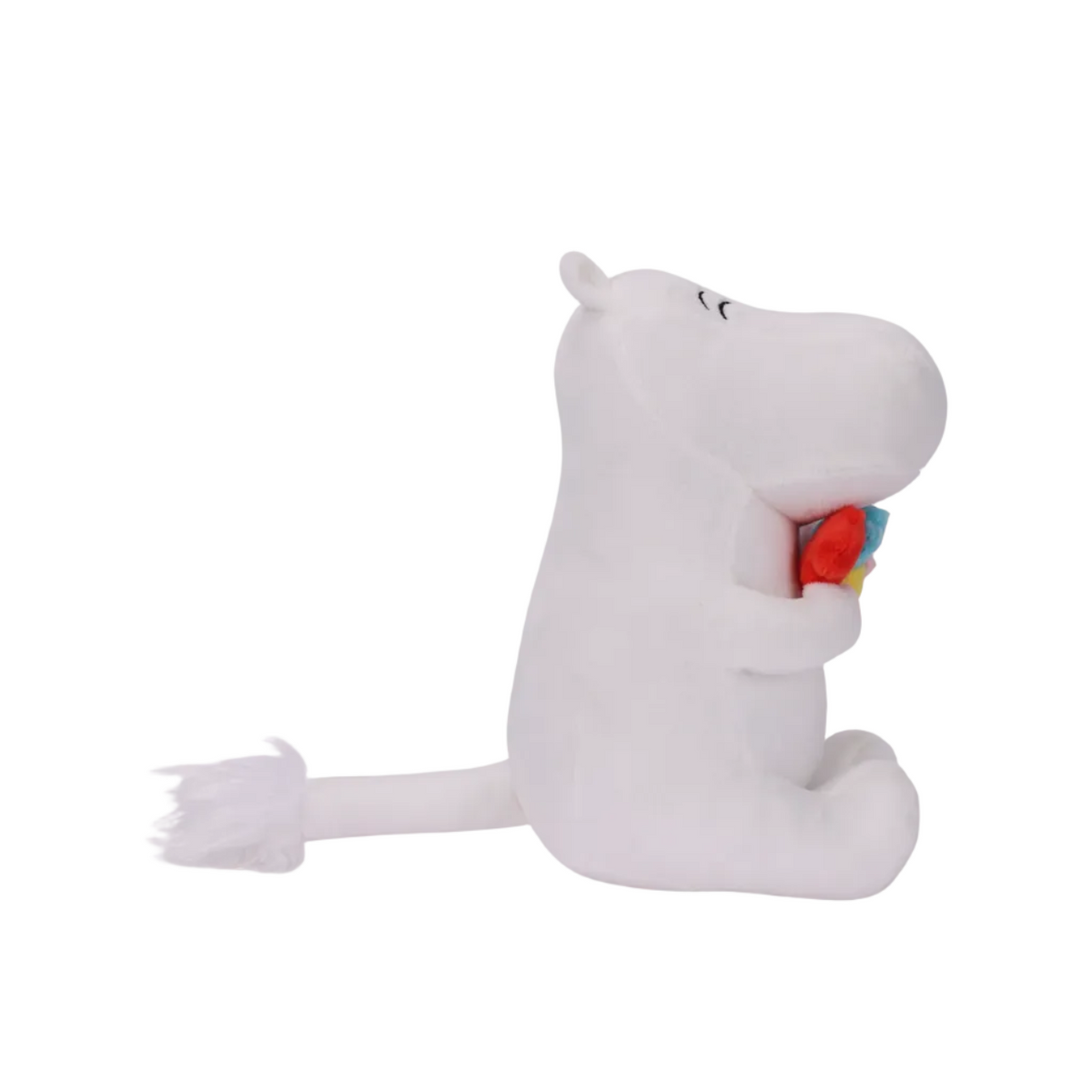 A white plush hippo toy sitting and holding a small multicolored heart-shaped toy, photographed on a clean white background.