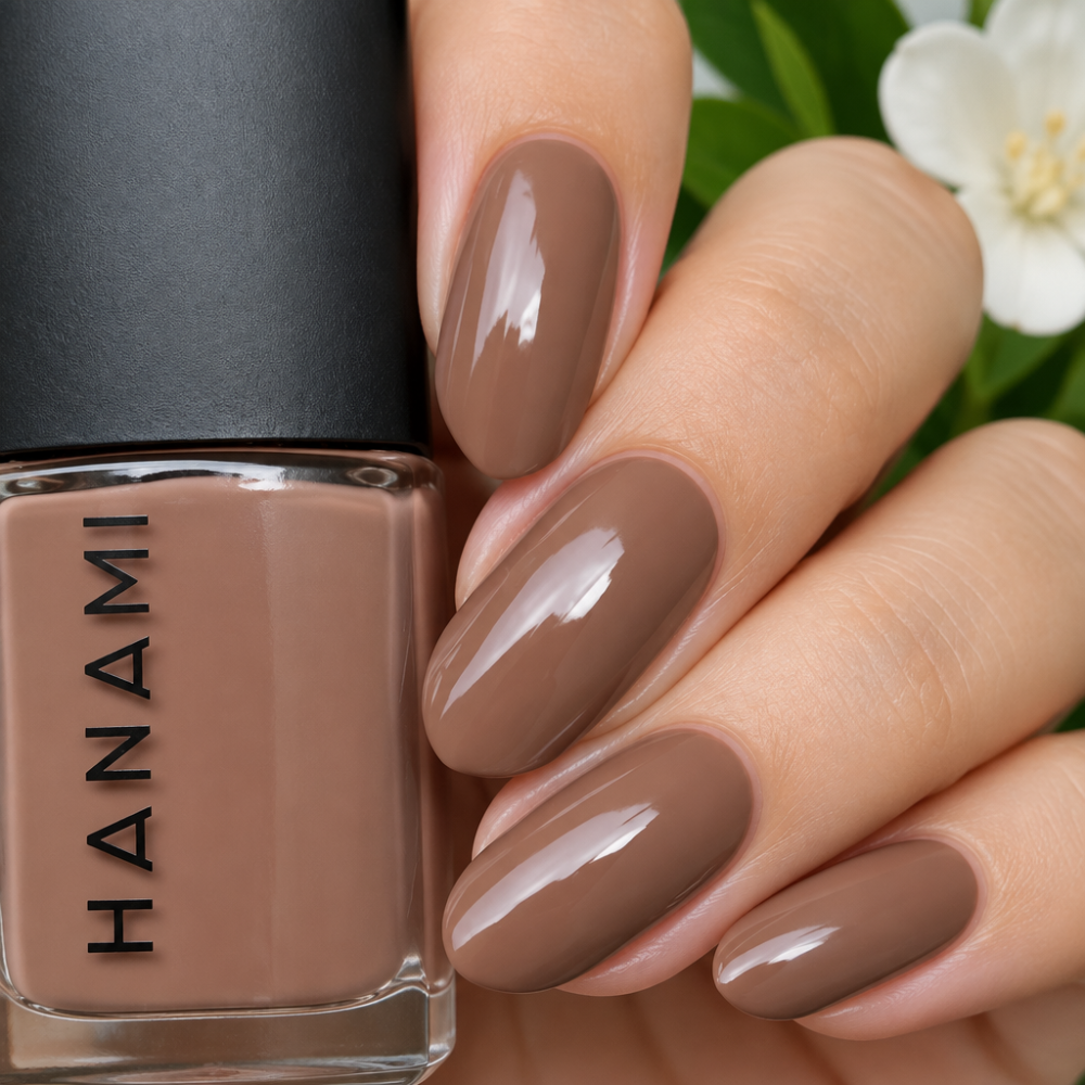 Nail polish bottle with a hand showing nails painted with the same color
