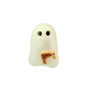 A ceramic ghost-shaped object in warm off-white with two dark eye holes and a small brown kiwi bird figure with a yellow beak attached near the lower front, photographed on a light gray studio background.