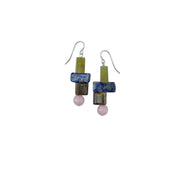 A pair of handmade dangle earrings featuring stacked rectangular beads in olive green, blue, brown, and pink, suspended from silver fishhook wires on a plain white background.