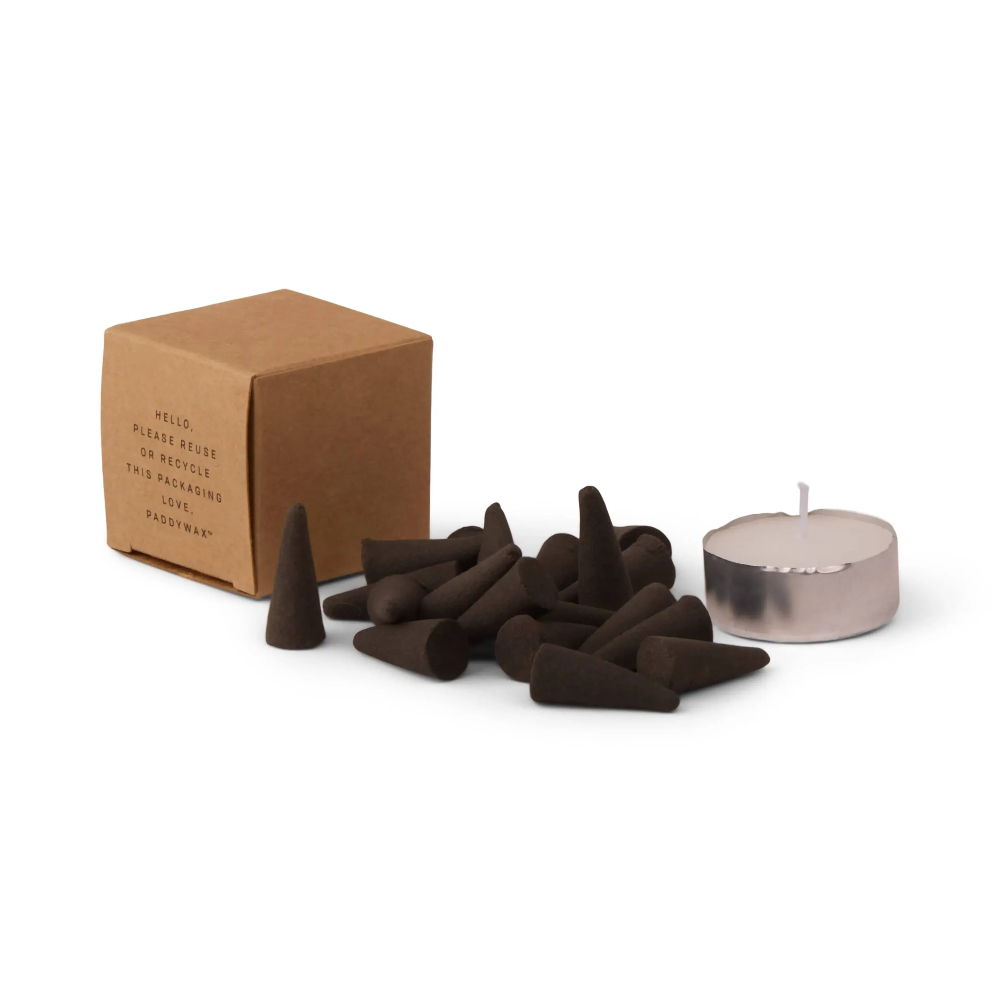 Incense cones and a candle with a cardboard box on a white background