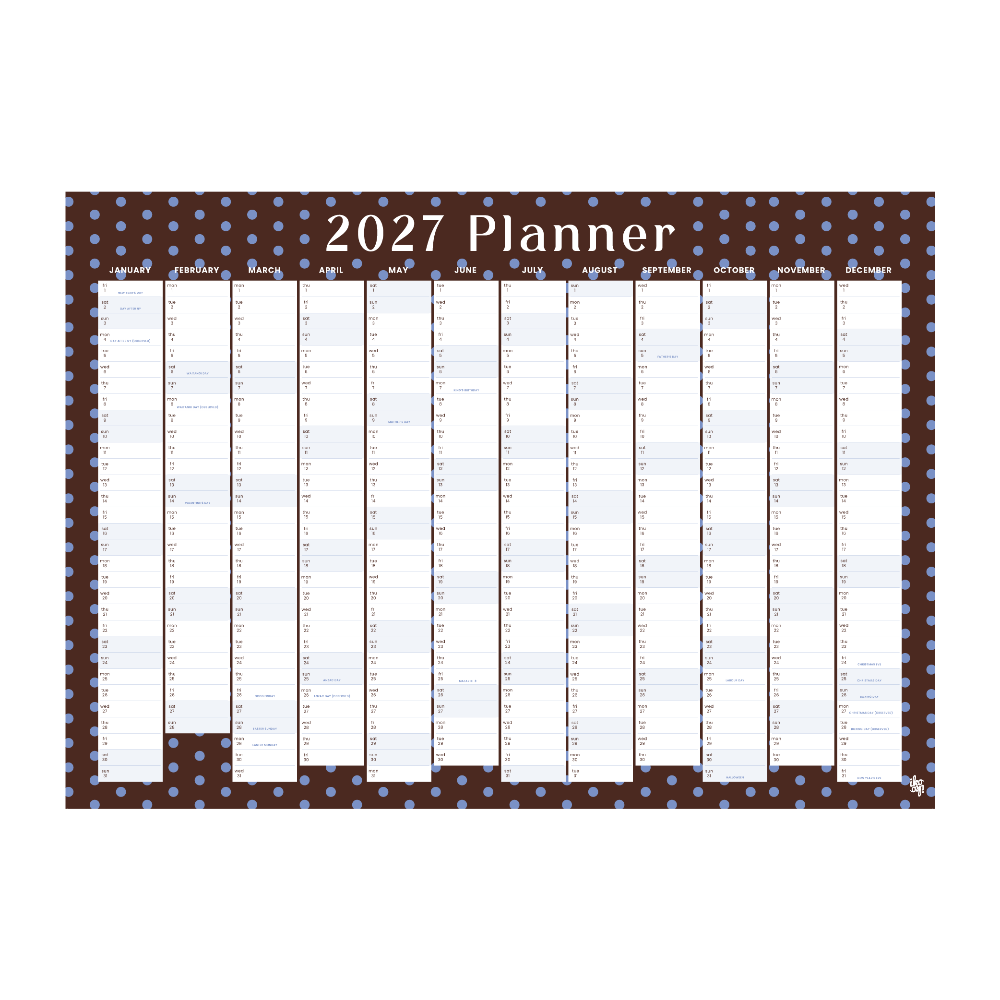 A 2027 planner desk calendar with a dark brown background, light blue polka dots, and white monthly columns, shown on a plain white background.