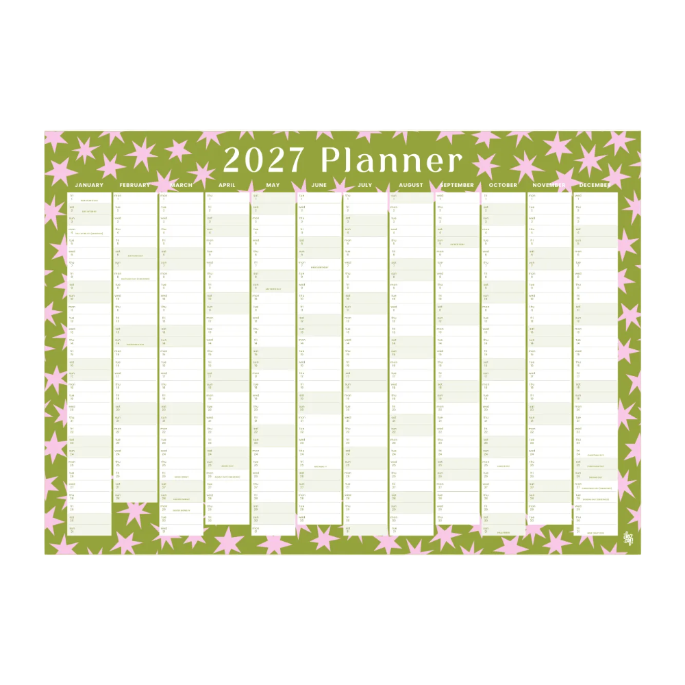 A 2027 planner desk pad featuring a sage green background decorated with pink stars, with a white grid layout for daily planning.