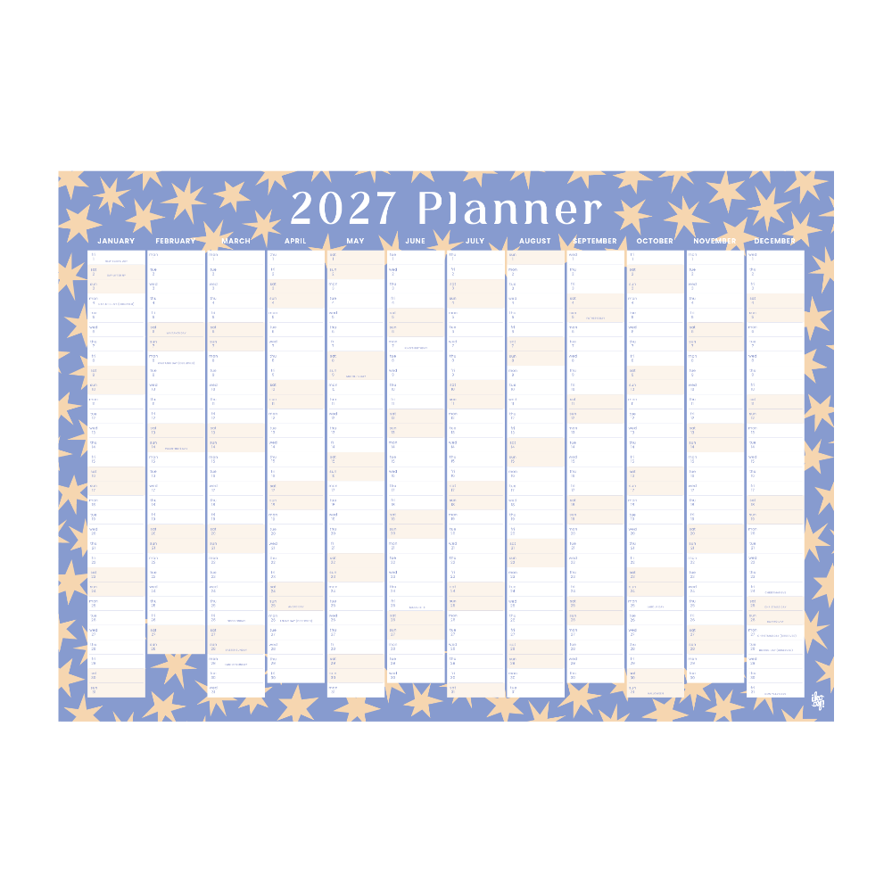 A 2027 planner desk calendar with a dusty blue background decorated with a border of gold stars. The center features twelve vertical columns for each day of the week, with white and light beige boxes for writing down plans and tasks.