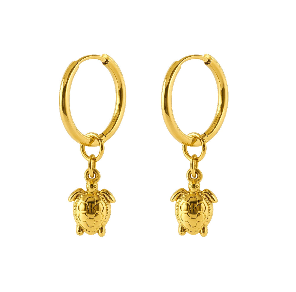 A pair of gold hoop earrings with small turtle charms hanging from the hoops, shown on a plain white background.