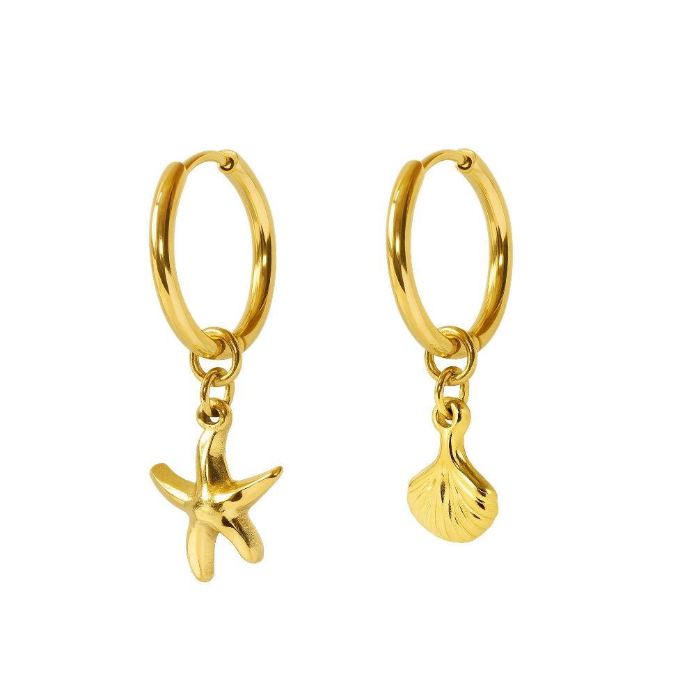 A pair of gold huggie hoop earrings with dangling starfish and seashell charms, shown on a plain white background.