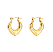A pair of gold huggie hoop earrings with a polished, wavy, rounded triangular design on a solid white background.
