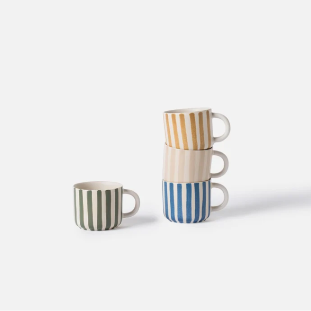 Set of three striped ceramic mugs on a white background