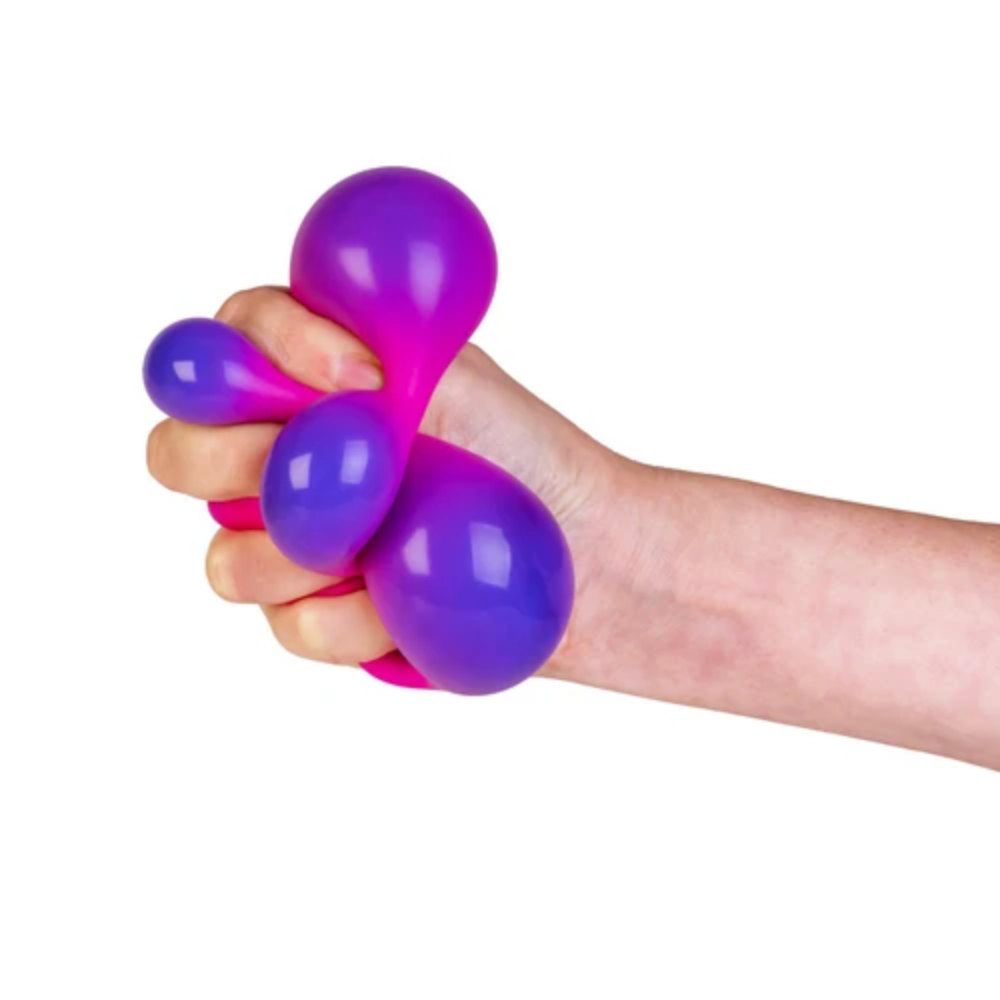 Hand holding a purple and pink stress ball against a white background