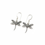 A pair of silver dragonfly drop earrings with detailed wing patterns and textured bodies