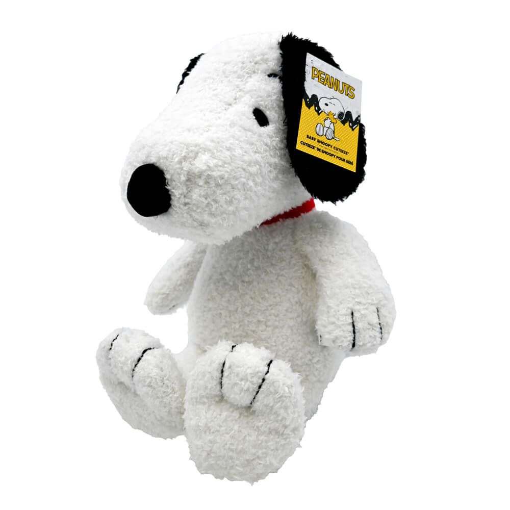 A white plush stuffed dog toy with black ears, a black nose, and a red collar, shown on a plain white background. A Peanuts tag is attached to one ear.