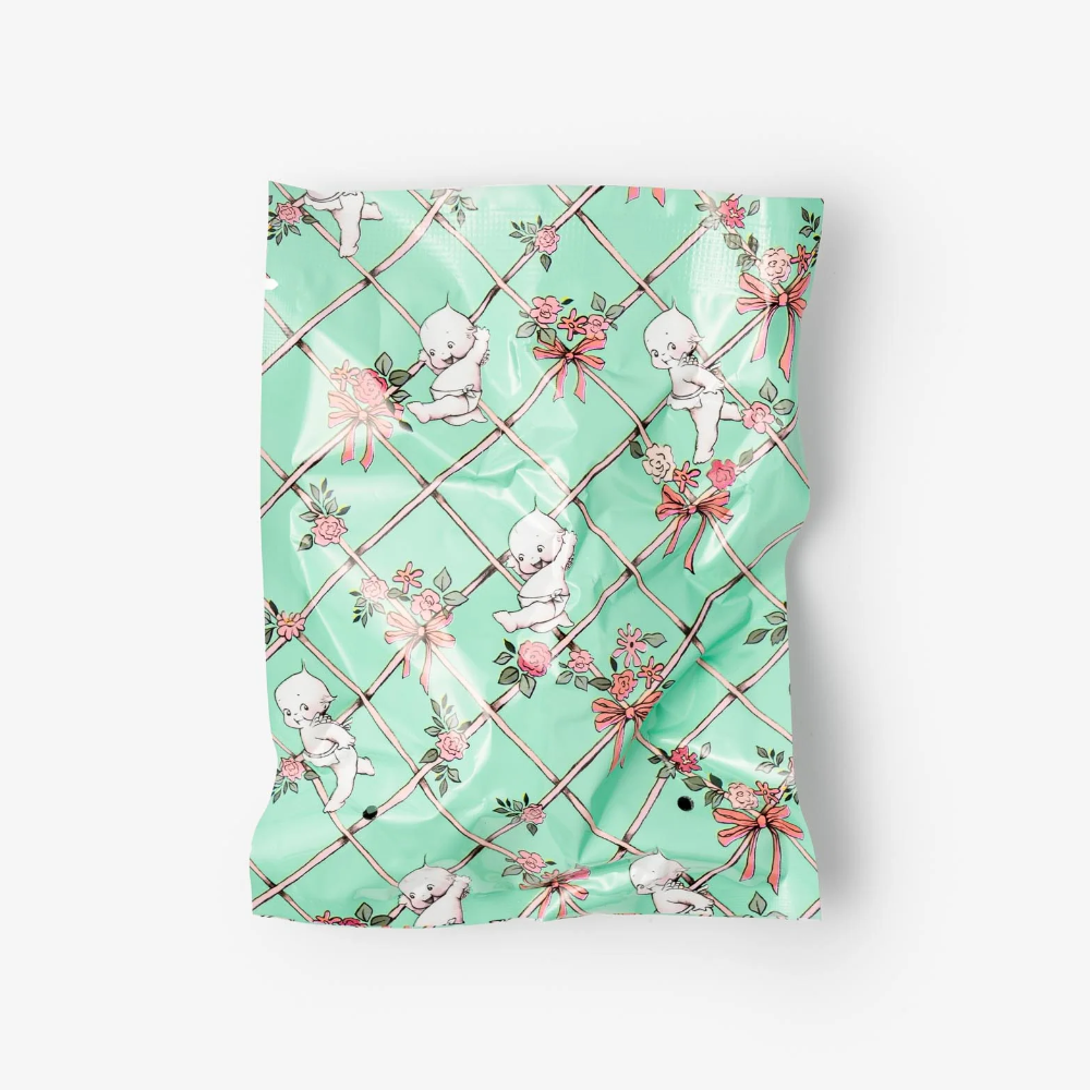 Green patterned fabric with cherub designs on a white background