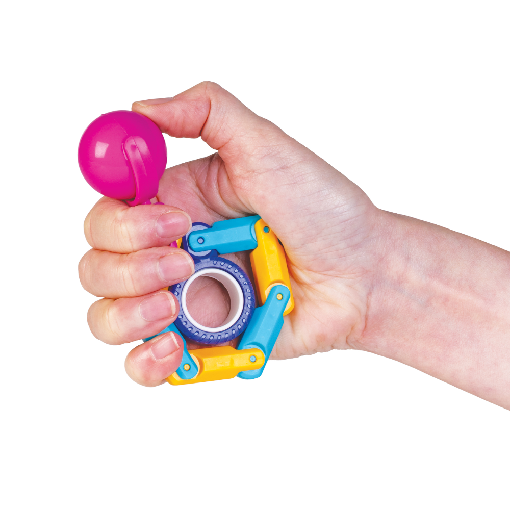 Hand holding a colorful toy with a pink ball on a white background