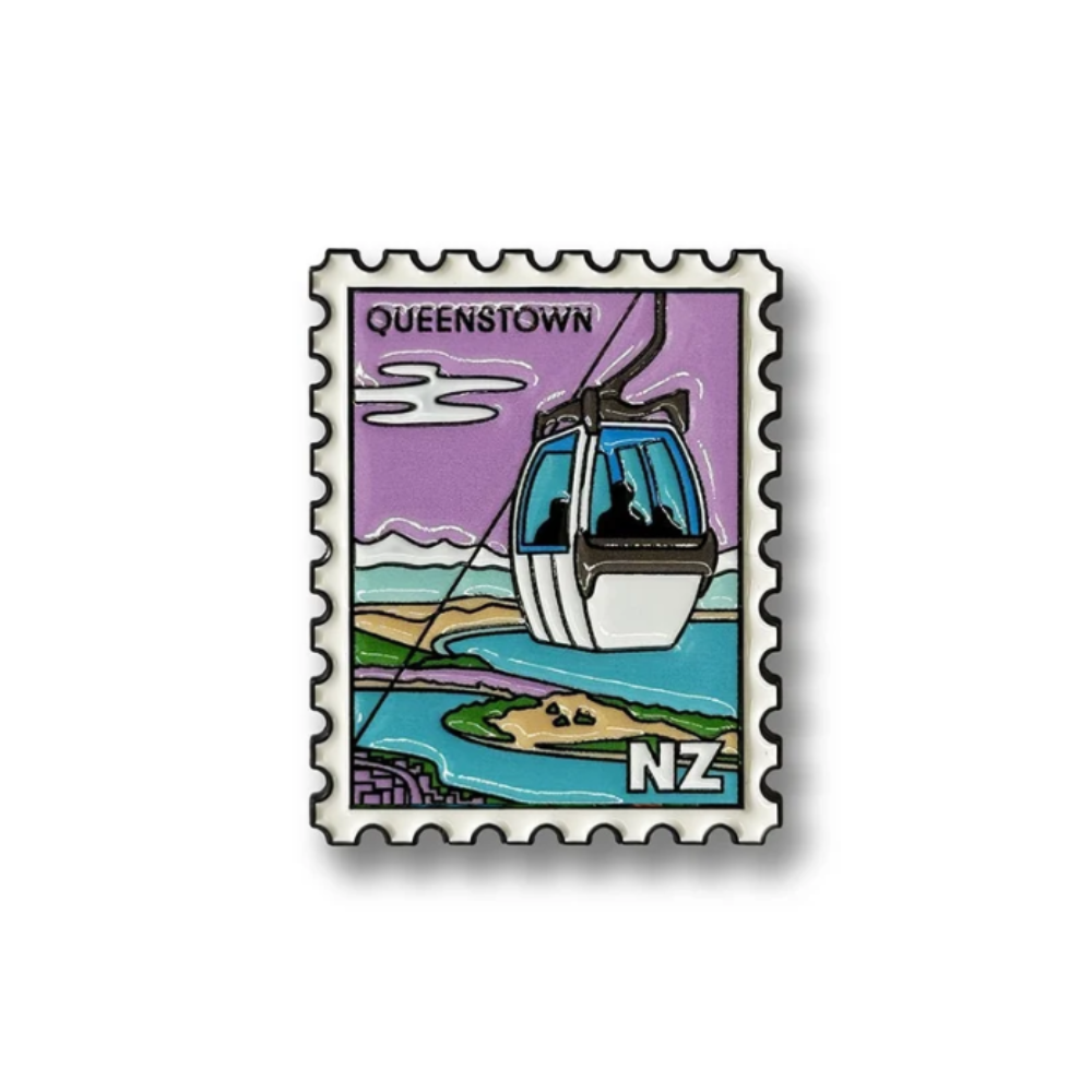 A square enamel pin designed like a vintage postage stamp with perforated edges, featuring an illustration of a cable car over Queenstown, New Zealand, with the text 'QUEENSTOWN' and 'NZ'.