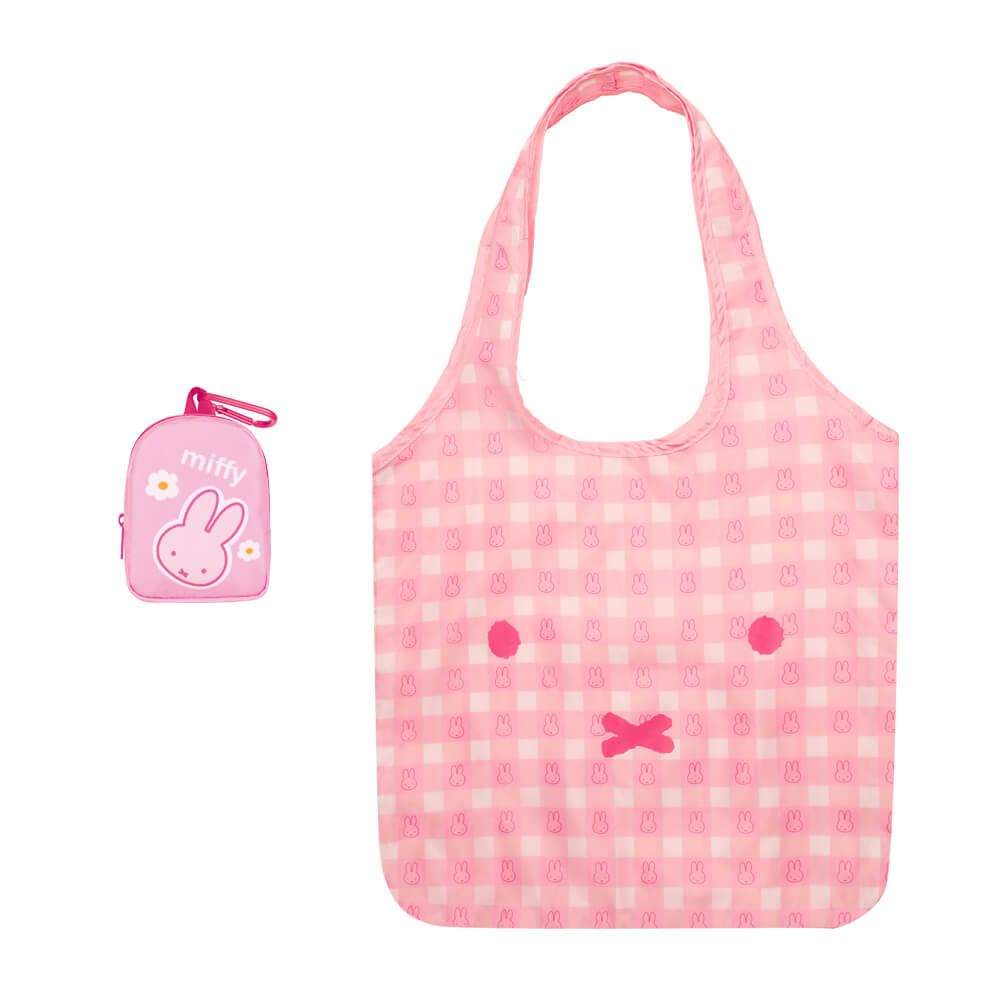 Pink checkered tote bag with cartoon face design on a white background