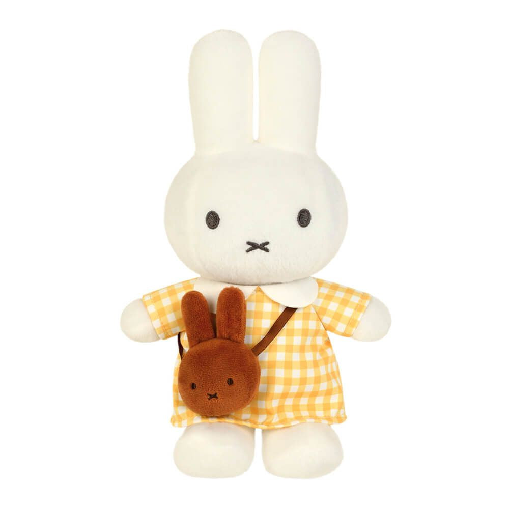 A white plush bunny doll wearing a yellow and white gingham dress, holding a small brown bunny-shaped backpack, shown against a plain white background.