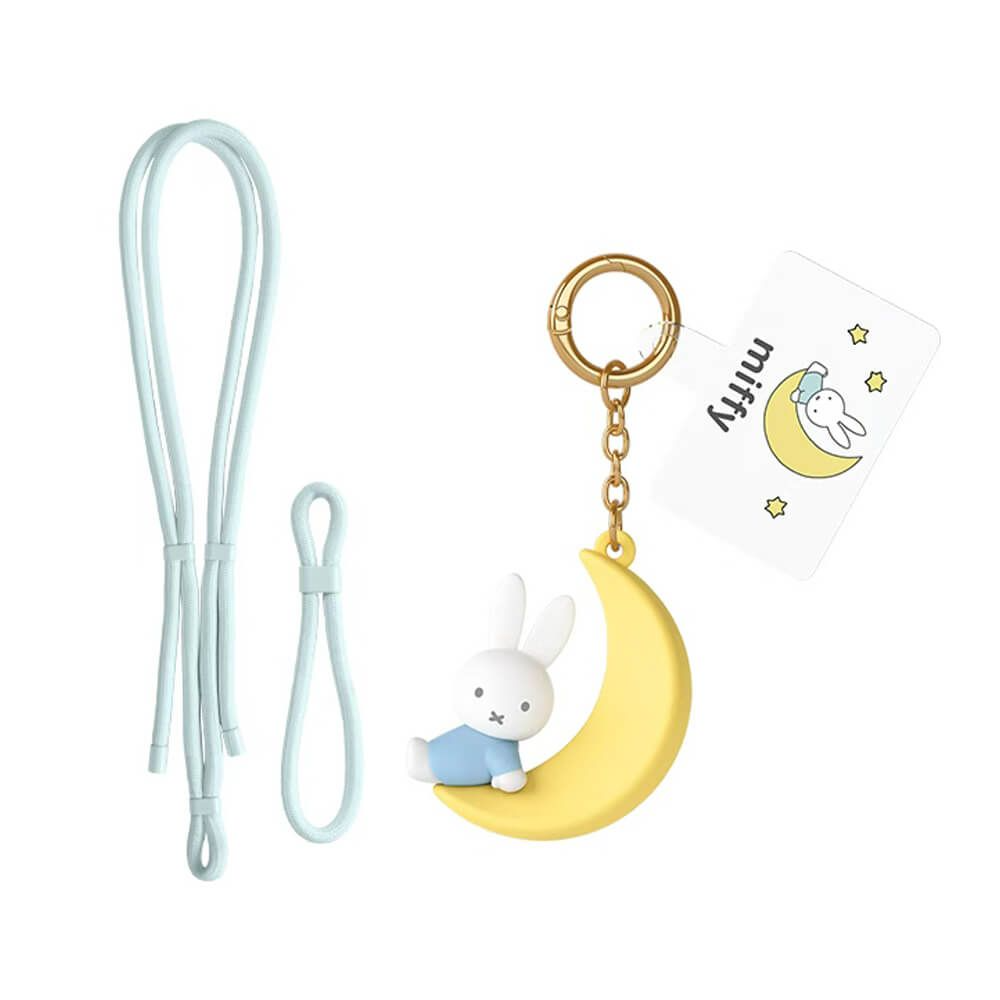 A Miffy keychain accessory set on a white background, featuring a yellow crescent moon charm with a white rabbit character sitting on it, a gold key ring and chain, a white hanging tag with the Miffy logo, and two pale blue straps.