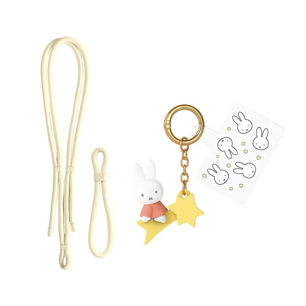 A Miffy-inspired keychain accessory set on a white background, featuring a cream-colored strap, a gold metal key ring, a small white bunny figure in a pink dress sitting on a yellow star charm, and a sticker sheet with bunny illustrations.