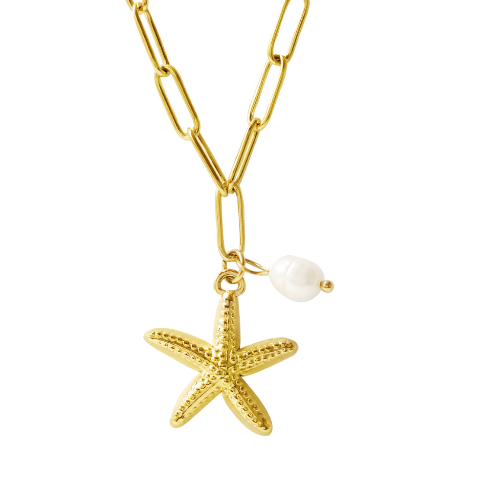A gold paperclip chain necklace featuring a textured gold starfish pendant and a small white pearl bead, shown on a plain white background.