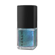 A bottle of Hanami nail polish with a black cap and a clear glass base showing a shimmering, iridescent blue-green nail polish.