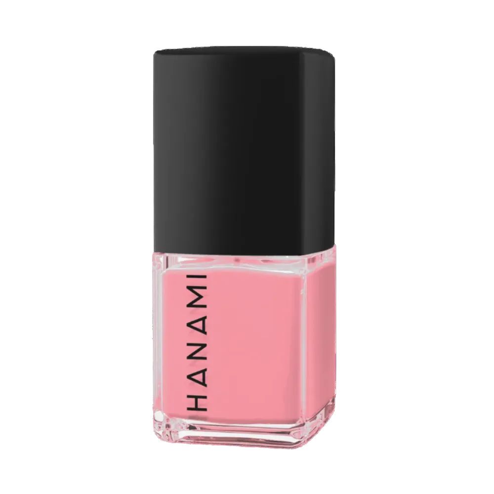 A bottle of Hanami nail polish in a soft pink shade, featuring a black cap and a clear glass base with the brand name printed vertically in black.
