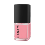 A bottle of Hanami nail polish in a soft pink shade, featuring a black cap and a clear glass base with the brand name printed vertically in black.