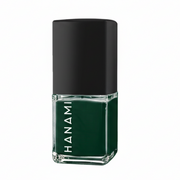 A bottle of Hanami nail polish in a deep forest green shade, featuring a black cap and a clear glass base with the brand name printed vertically in white.