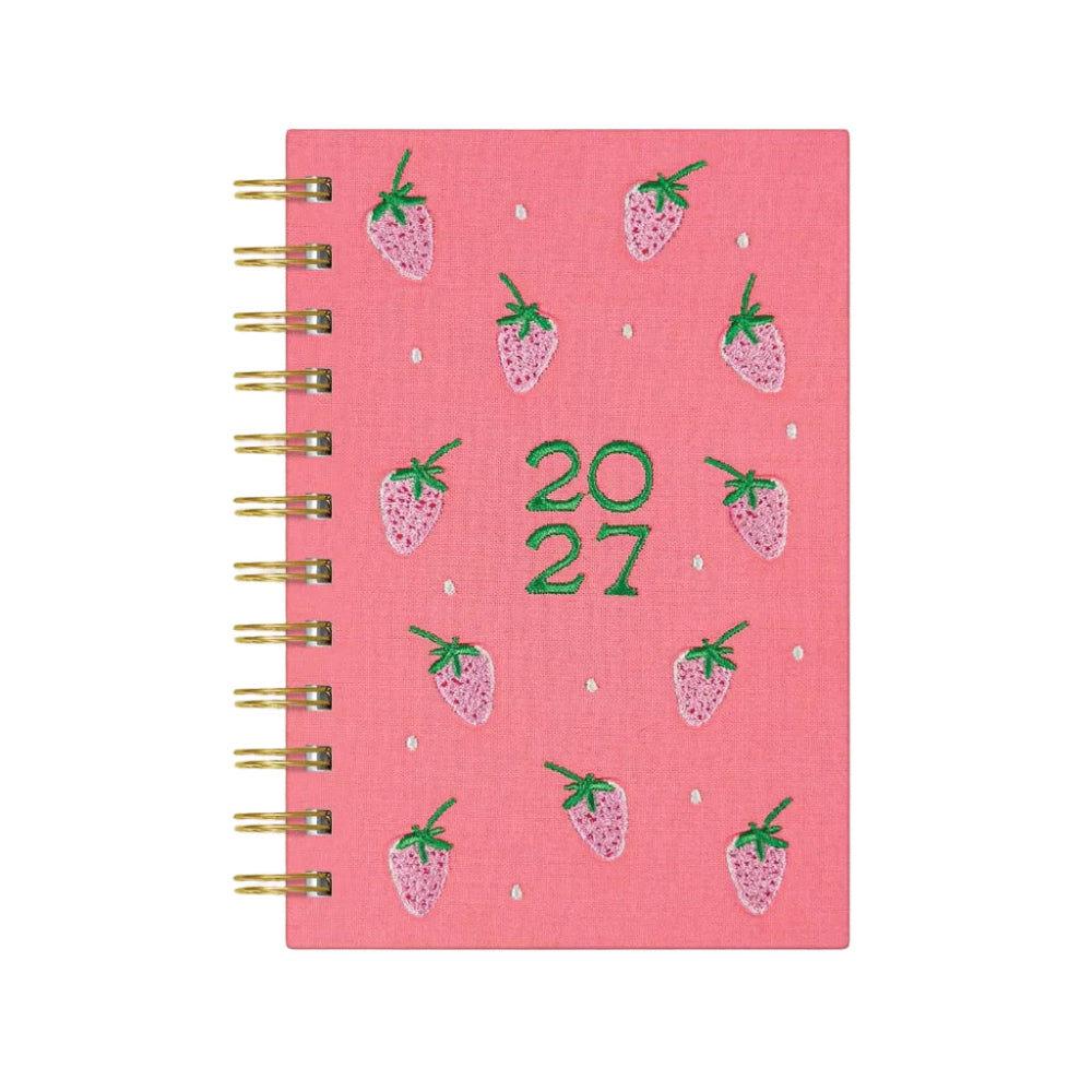 A pink spiral-bound 2027 planner featuring embroidered strawberry motifs and green '20 27' text on the cover, shown on a white background.